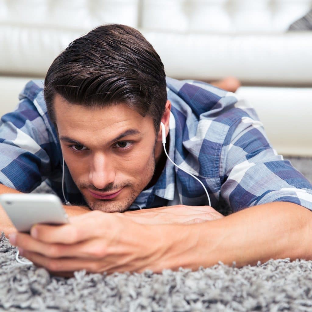 Man using smartphone on the floor